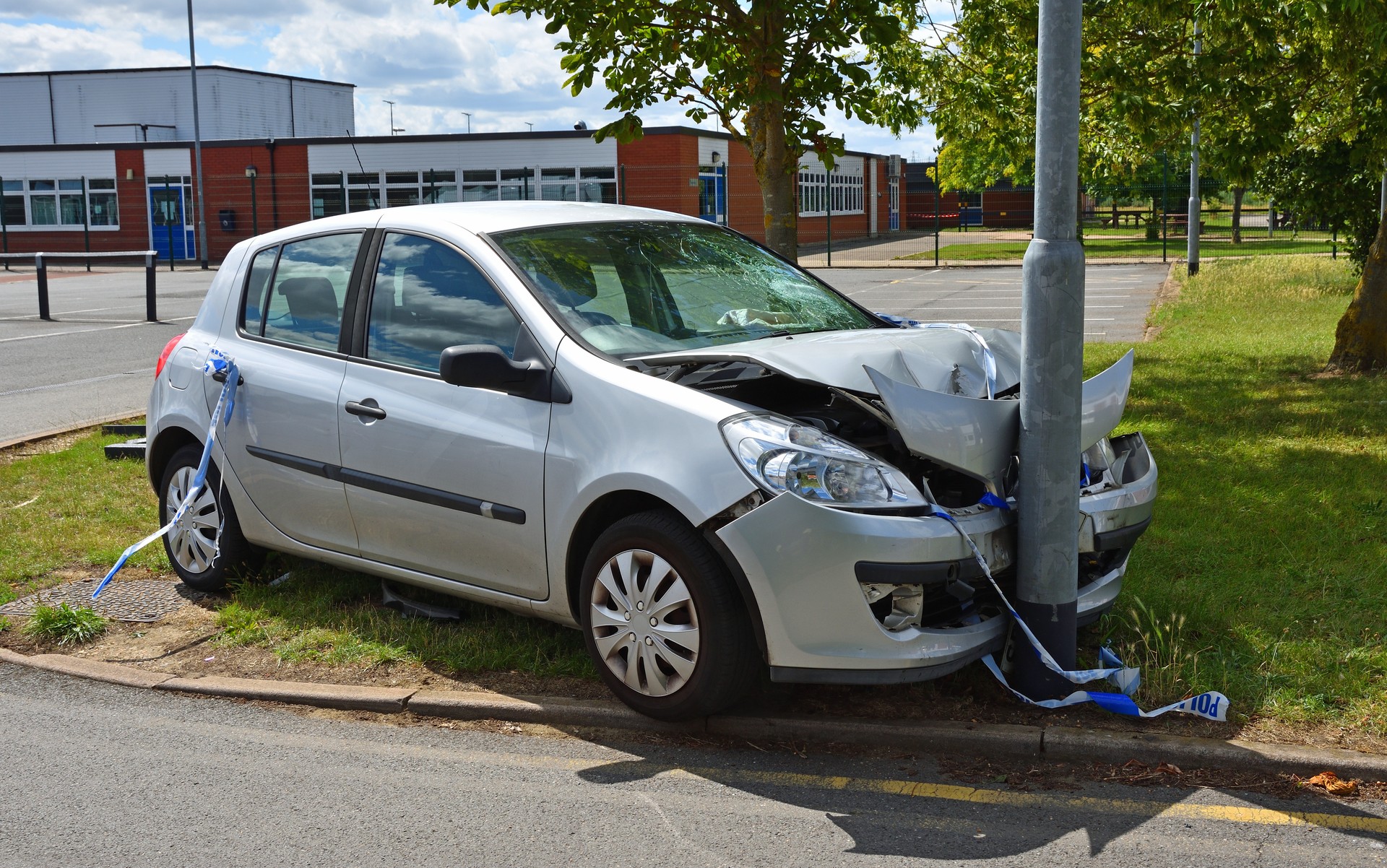 Car crashed into lamp post near car park exit.